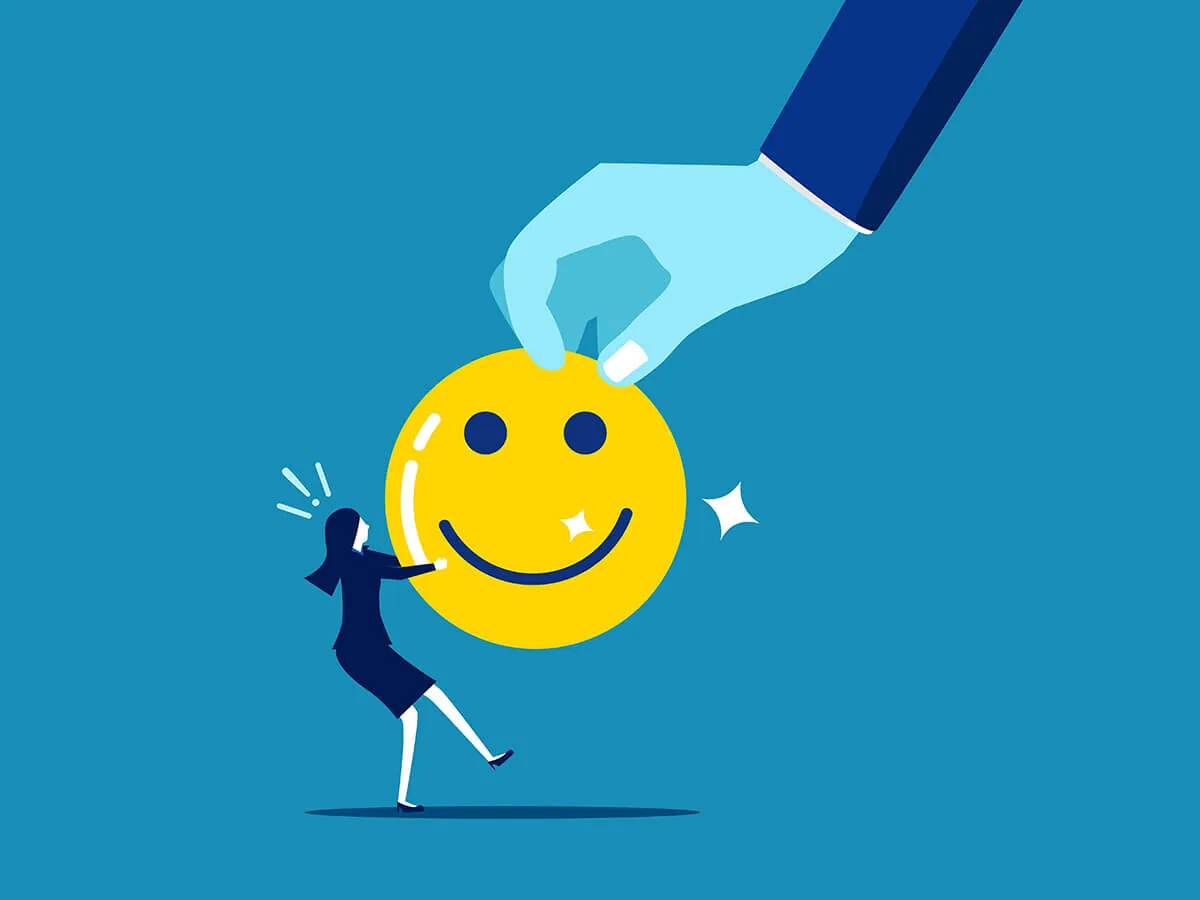 Donna stilizzata interagisce con una grande faccina sorridente tenuta da una mano, simbolo di umorismo nell’eLearning