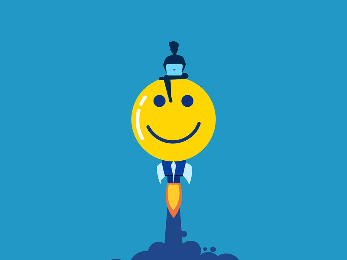 Faccina sorridente con cravatta e razzo, persona con laptop seduta sopra, simbolo di umorismo nell’eLearning