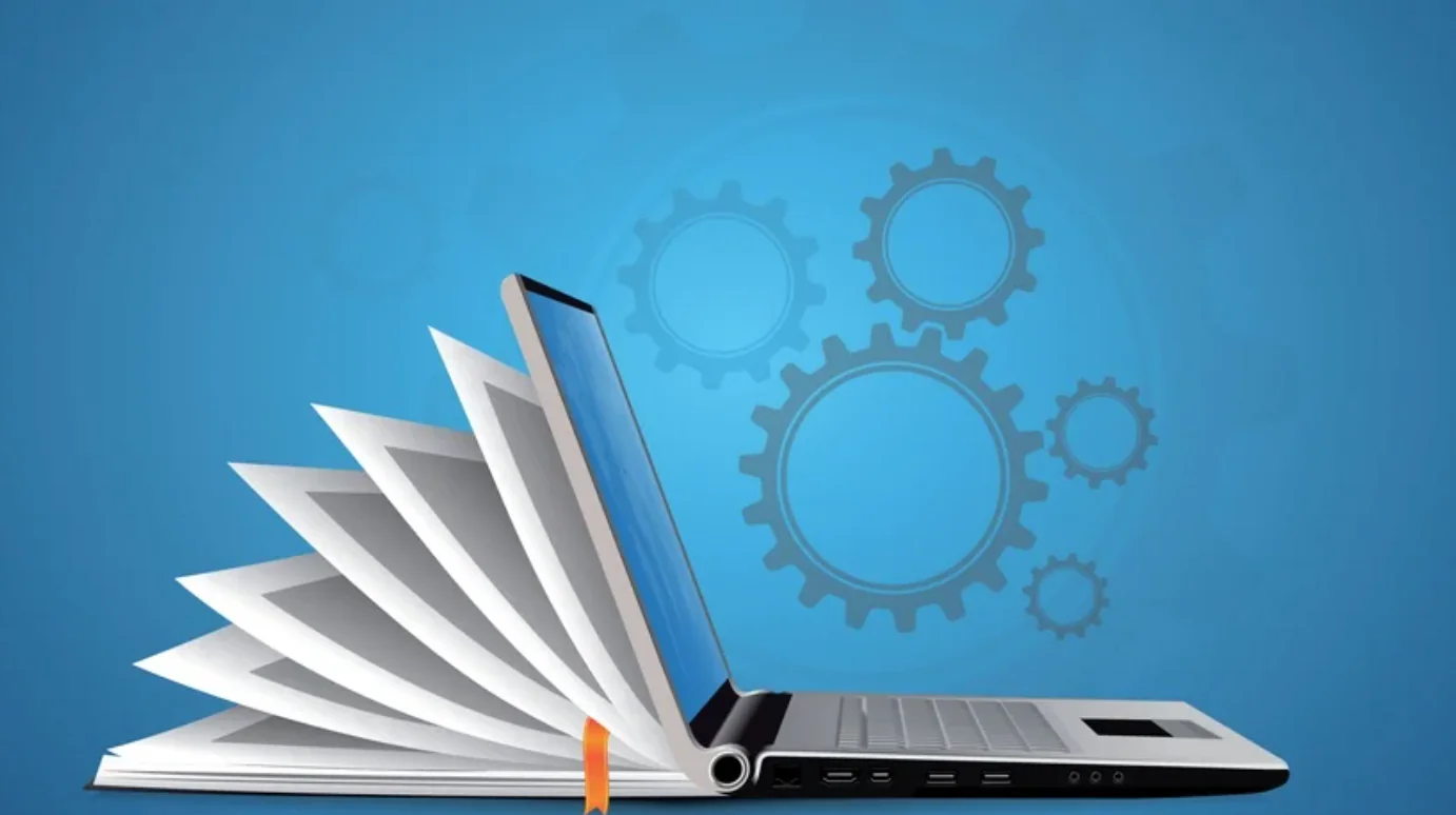 Laptop stilizzato con pagine di libro aperte e ingranaggi su sfondo blu, simbolo di visual design nell'e-learning